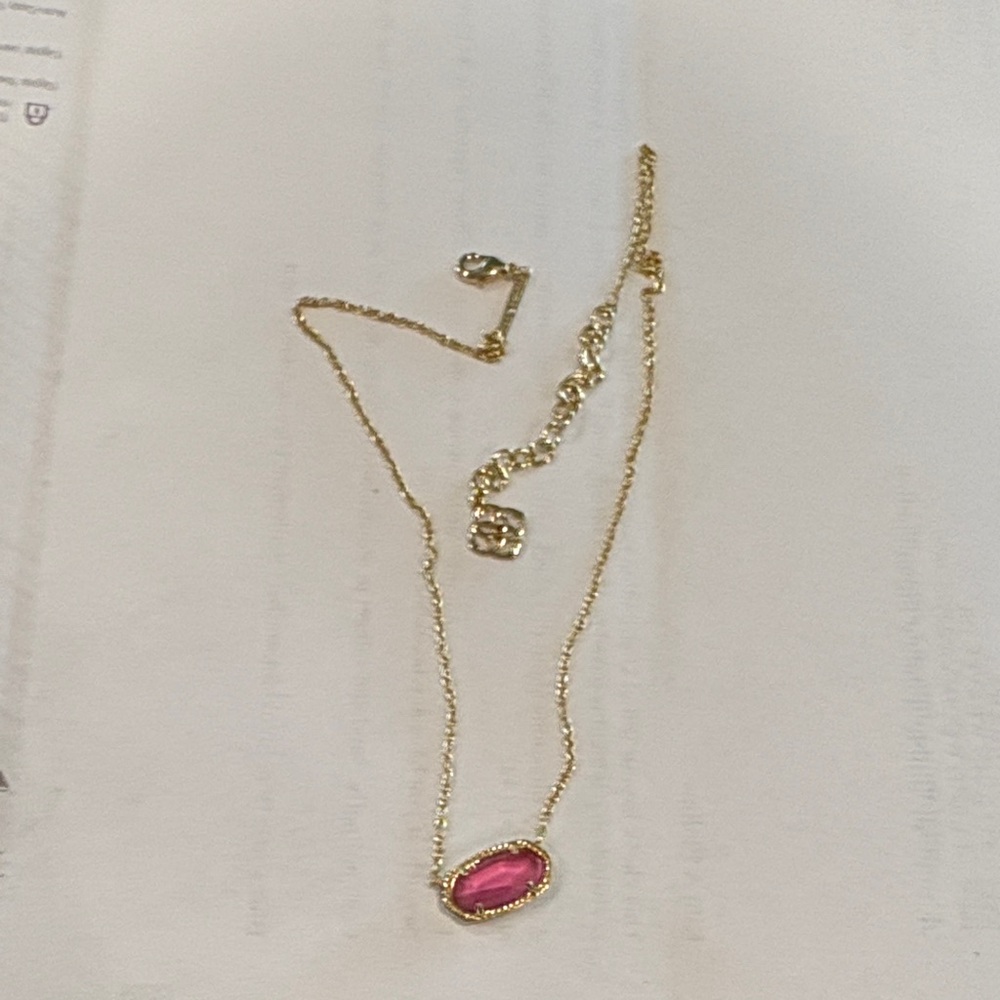 Kendra Scott gold necklace with pink stone